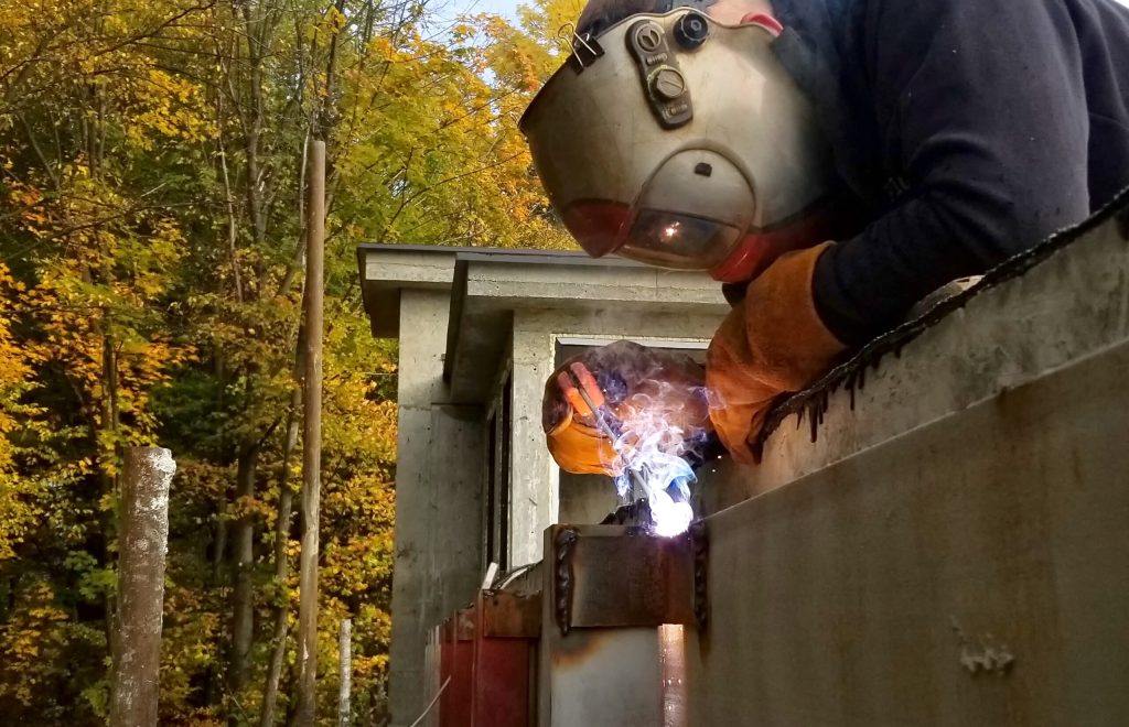 Welding work, welder welding metal material in heavy industry manufacturing